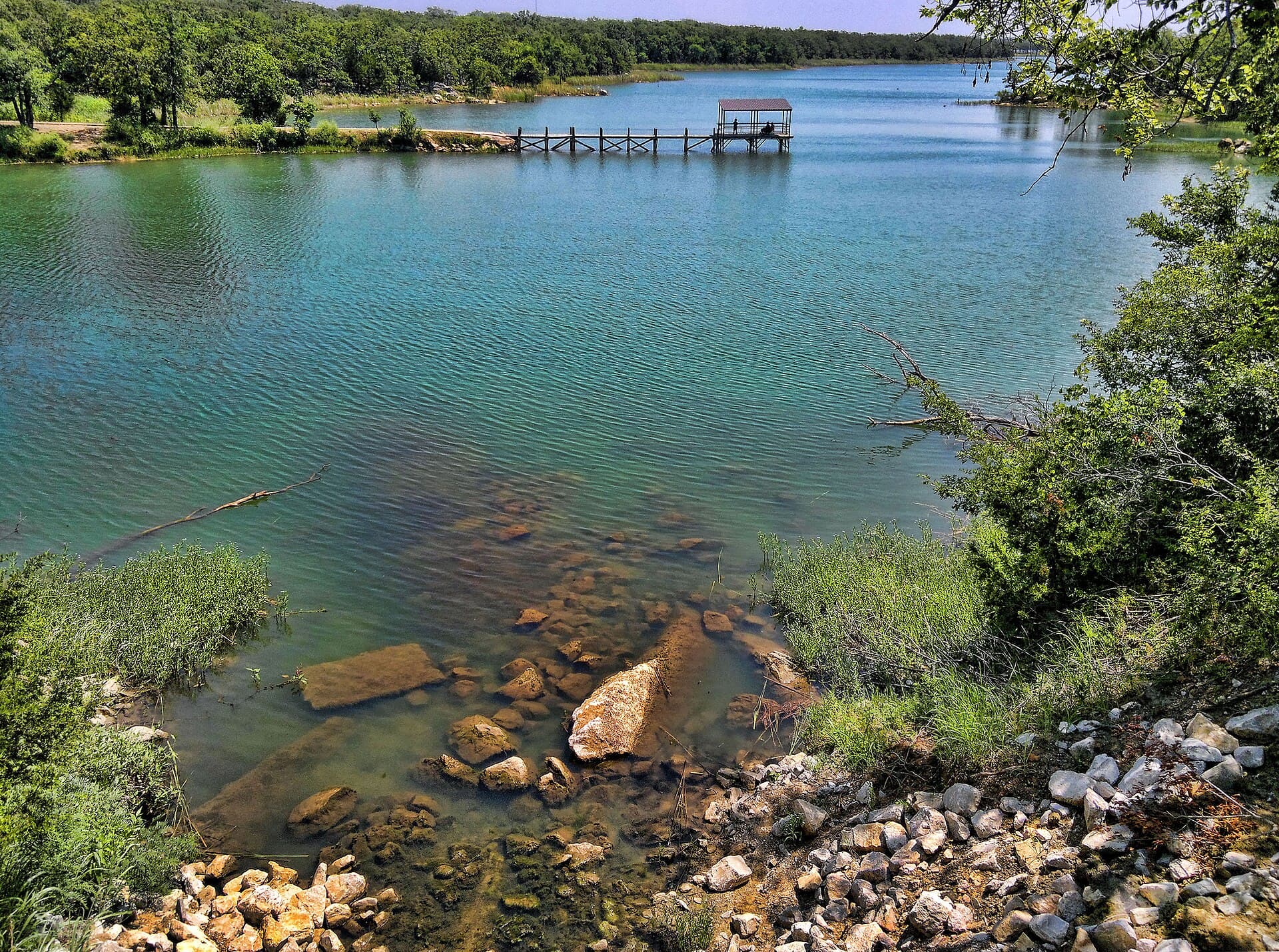 Fishing pier reaching across the clear water at Lake Murray